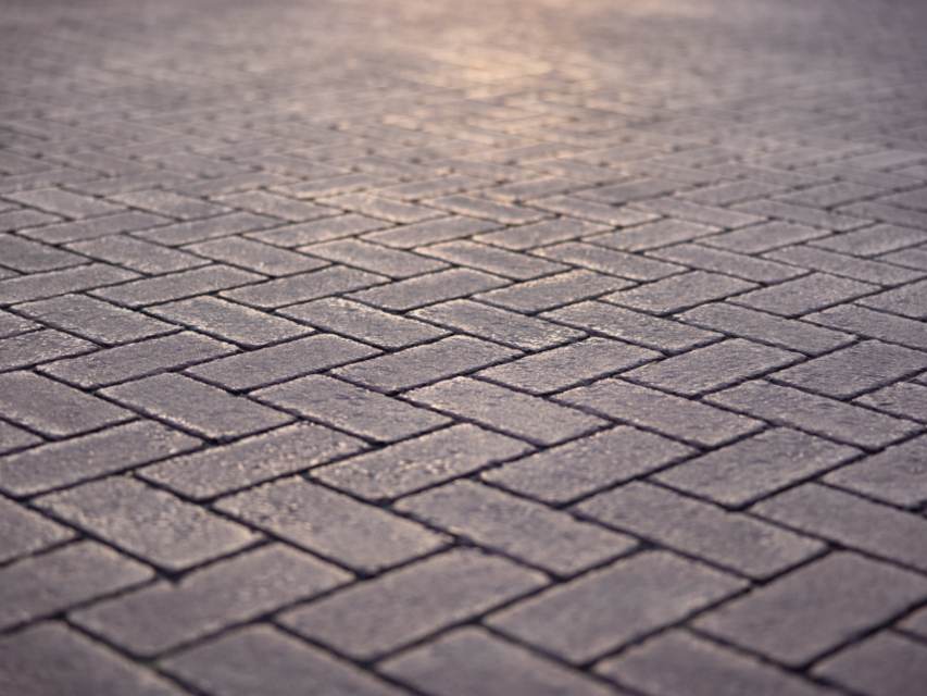 Close-up of gray pavers laid in a herringbone pattern
